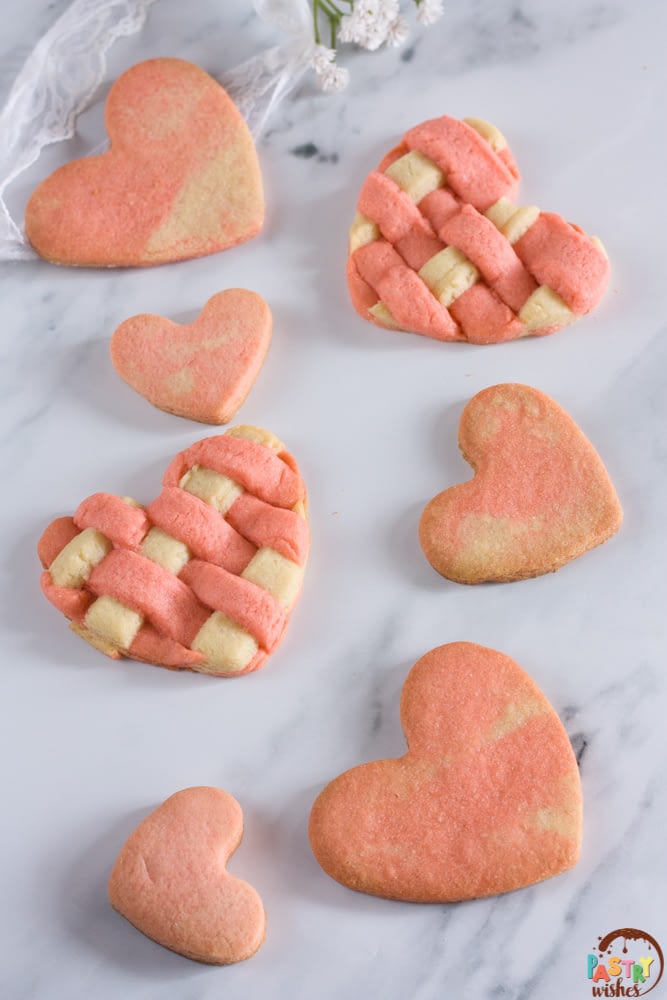 lattice and marbled heart sugar cookies on a white countertop
